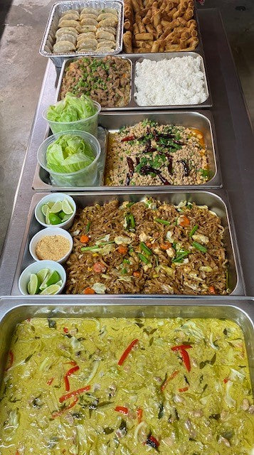 Shows dishes laid out prior to being placed in sealed warmer box for transport